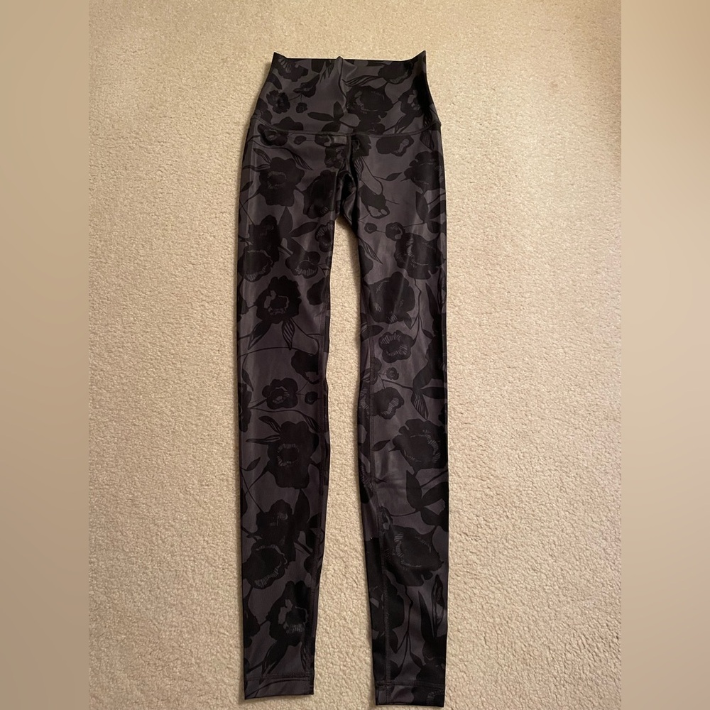 Size 4 black lululemon leggings with monochromatic flower pattern- never worn